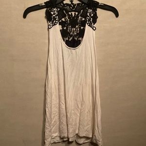 white/cream tank top with black lace shoulders and back.